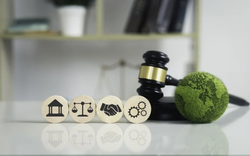 Wooden tokens with legal, handshake, and gear icons next to a gavel and globe, symbolizing securities litigation.
